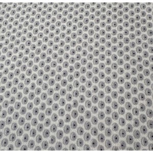 May include: Close-up of a fabric with a repeating pattern of gray circles with a dark center on a white background. The circles are evenly spaced, creating a textured appearance. The fabric appears to be a woven material.