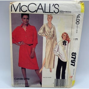 May include: A set of three ceramic mugs with a speckled, matte finish. The mugs are in shades of cream, light gray, and dark gray. Each mug has a simple, minimalist design and a rounded handle. The mugs are suitable for coffee or tea.