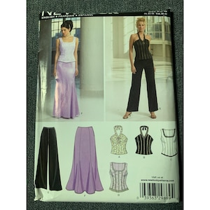 May include: A sewing pattern featuring illustrations of formal wear, including a lavender mermaid skirt, black pants, and various tops. The pattern includes the text "ENGLISH FRANÇAIS ESPANOL" and "FR. 34-44 EUR. 32-42".