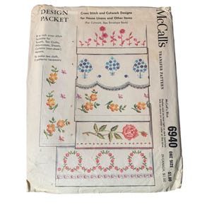 May include: McCall's Transfer Pattern 6940, a vintage cross stitch and cutwork design packet for house linens and other items. The packet includes five different designs featuring floral motifs in shades of pink, blue, yellow, and green. The text on the packet reads "McCall's Transfer Pattern 6940 One Size $1.00 In Canada $1.00".