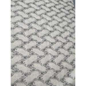 May include: A fabric with a repeating pattern of swirling, cloud-like shapes in black and gray against a white background. The design is evenly spaced, creating a textured appearance. The fabric appears to be a textile.