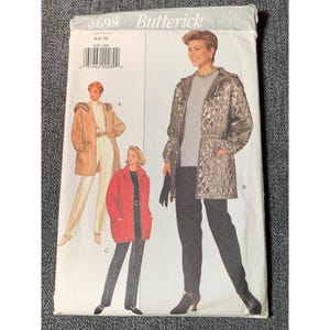 May include: A vintage Butterick sewing pattern envelope featuring illustrations of women's coats. The envelope has the number 3698 and size 6-8-10 printed on it. The coats are in various colors, including tan, red, and silver.