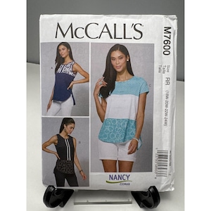 May include: McCall's M7600 sewing pattern featuring three top designs. The pattern includes sizes RR (18W-20W-22W-24W). The cover shows illustrations of the tops and the text "NANCY ZIEMAN".