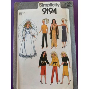 May include: Simplicity 9194 doll pattern. The pattern features illustrations of a doll in various outfits, including a wedding dress, jumpsuit, and skirt sets. The pattern is for an 11.5-inch doll. The price is $2.00.