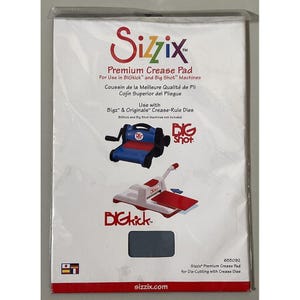 May include: A Sizzix Premium Crease Pad package. The package features the Sizzix logo in red, product information, and illustrations of die-cutting machines. The text includes "Premium Crease Pad" and "For Use in BIGkick and Big Shot Machines."