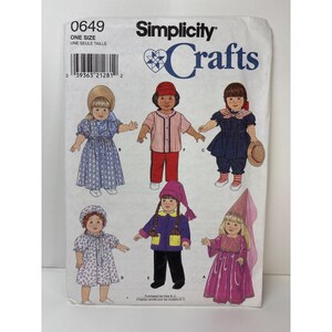 May include: Simplicity Crafts pattern 0649 featuring illustrations of children's clothing designs. The designs include a blue dress, a striped shirt and red pants, a navy blue outfit, a floral dress, a purple coat and black pants, and a pink princess dress.