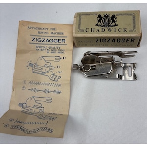 May include: A silver metal sewing machine zigzagger attachment with its original cardboard box labeled CMI Inc. Chadwick and a beige instruction sheet featuring diagrams and text detailing patent numbers and stitch patterns for the device.