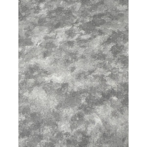 May include: A close-up shot of a textured fabric with a mottled appearance. The fabric features a blend of gray and white hues, creating a cloudy or marbled effect. The surface has a soft, velvety texture.