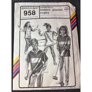 May include: Vintage sewing pattern for children's rugby shirts, featuring illustrations of the designs. The pattern, labeled "958," includes chest sizes 21-31 inches. Designed by Ann Person, it is from Stretch & Sew, Inc.