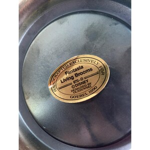 May include: A gold sticker with the text "Handcrafted Exclusively for Fantasia Living Brooms 972-D &copy;DISNEY Designed by Olszewski Goebel 1990"