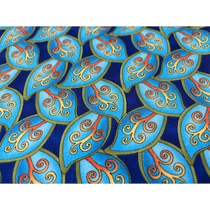 May include: Close-up of a blue fabric with a repeating pattern of stylized leaf shapes. Each leaf is a vibrant blue with yellow and orange swirls, outlined in green, set against a dark blue background.
