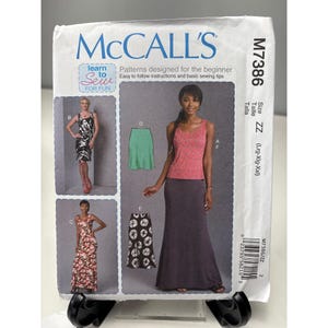 May include: McCall's sewing pattern M7386 for beginner sewers. The pattern includes instructions for making dresses and skirts. The package features images of the finished garments, including a maxi skirt and a tank top.