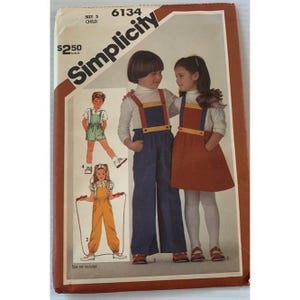 May include: Vintage Simplicity sewing pattern for children's overalls and a dress. The pattern features illustrations of children wearing the outfits. The pattern is size 5 and the price is $2.50.