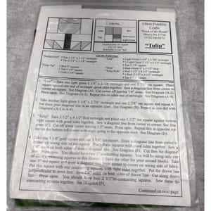 May include: A printed pattern for a fabric tulip quilt block. The instructions include cutting measurements in inches and diagrams for assembly. The color key shows gold, tan, red, dark green, and light green fabric swatches.