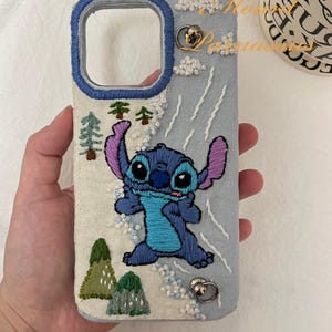 Custom Blue Patchwork Embroidered Phone Case – Featuring a Bold Blue Cartoon Character with Intricate Stone Motif, Pine Trees & Mountain