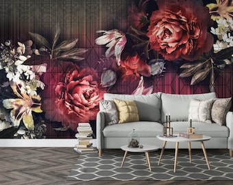 Pode incluir: Uma sala de estar com papel de parede floral com grandes peónias vermelhas e rosas. Um sofá cinza claro com almofadas decorativas fica em frente à parede. Duas pequenas mesas brancas e um tapete cinza estampado completam o ambiente.