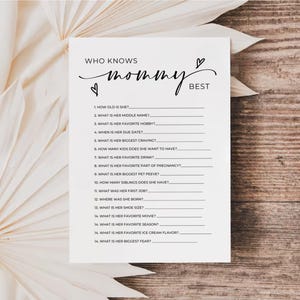 May include: A printable game card with the text "Who Knows Mommy Best?" and a list of questions about a mother-to-be.
