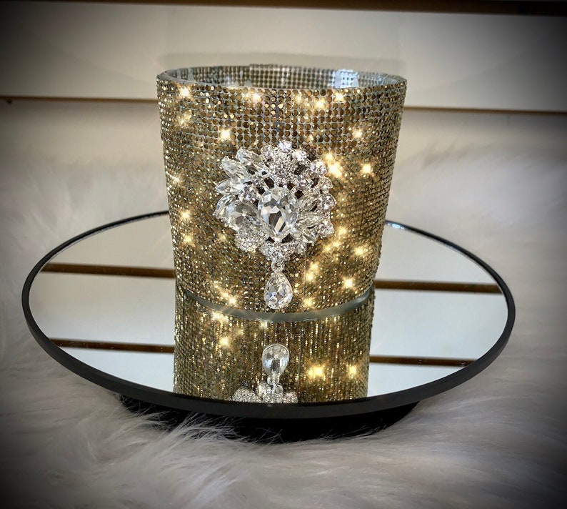 Gold crystal rhinestone container candle with clear crystal drop embellishment.
