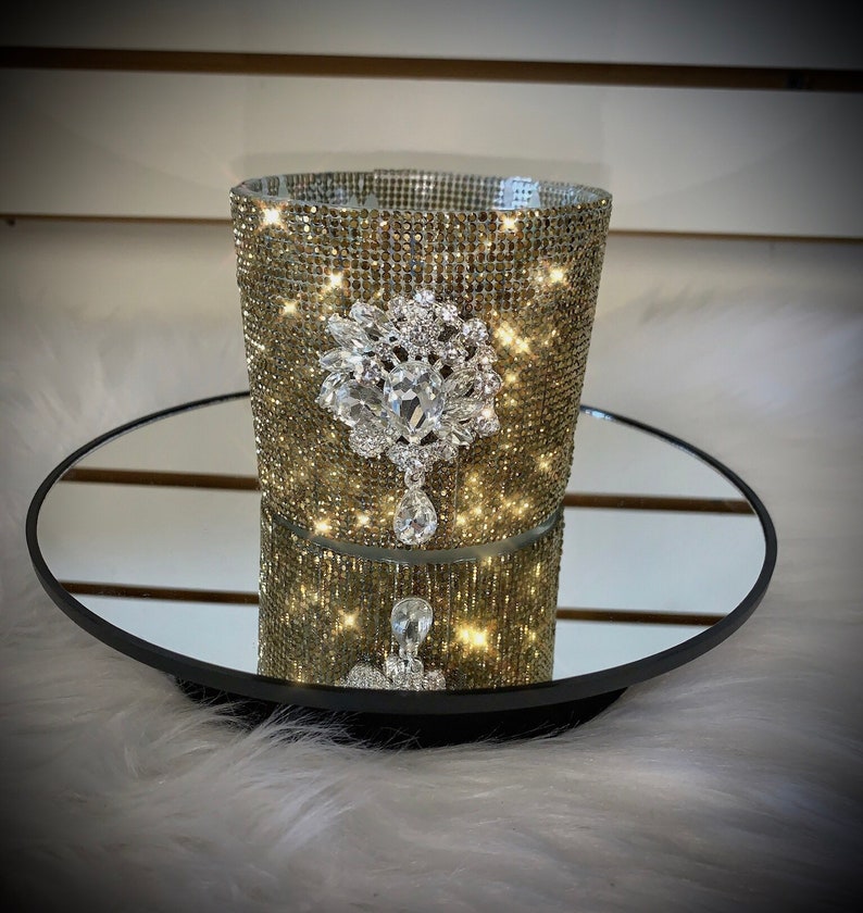 Gold crystal rhinestone container candle with clear crystal drop embellishment.