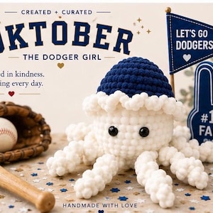 May include: A handmade crochet octopus wearing a blue hat and a white frill. A baseball, glove, and bat are next to the octopus. A foam hand and pennant flag that says "Let's Go Dodgers!" are also in the image. The text says "Oktober The Dodger Girl".