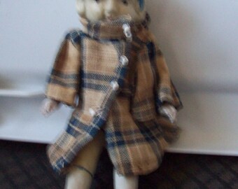 Antique Bisque Doll, Japan made. all four limbs move. original coat with her.