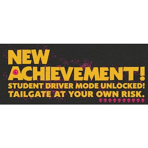 May include: A black rectangular sign with yellow text that reads "NEW ACHIEVEMENT! STUDENT DRIVER MODE UNLOCKED! TAILGATE AT YOUR OWN RISK." Pink splatter and skull graphics are also present.