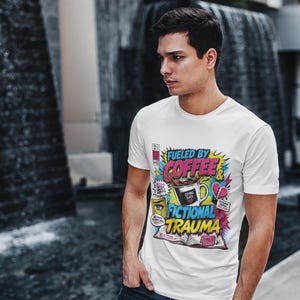 Young man wearing white Fueled by Coffee and Fictional Trauma bookish graphic tee in urban outdoor setting, funny reader shirt book lover gift