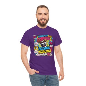 Man smiling in purple Fueled by Coffee and Fictional Trauma bookish graphic tee, full body shot, funny reader shirt gift for book lovers