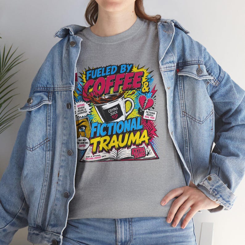 Woman in denim jacket layering over grey Fueled by Coffee and Fictional Trauma bookish graphic tee, colorful retro print, bookish outfit inspo