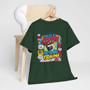 Dark green Fueled by Coffee and Fictional Trauma bookish graphic tee flat lay on wooden chair, product photo, funny reader shirt book lover gift