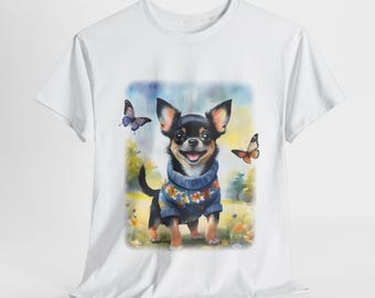 May include: White t-shirt with a colorful illustration of a chihuahua wearing a blue sweater and surrounded by butterflies.