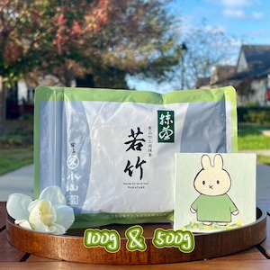 May include: A package of matcha tea with Japanese text and a cartoon bunny illustration. The package is labeled "Wakatake" and "Matcha for use in food." The text "1000g & 500g" is also visible.
