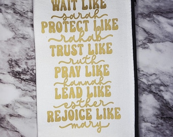 May include: White canvas zippered pouch with gold lettering that reads "Wait like Sarah, Protect like Rahab, Trust like Ruth, Pray like Hannah, Lead like Esther, Rejoice like Mary."