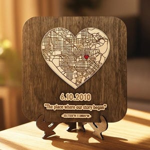 May include: Wooden heart-shaped map with a red heart marking a location. The map is mounted on a wooden plaque with the date 6.10.2010 and the text "The place where our story began". Coordinates are also included.