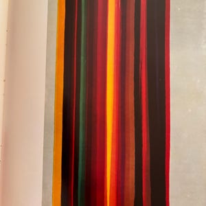 May include: Abstract painting with vertical stripes in shades of yellow, orange, red, brown, green, and black. The painting is on a white background.