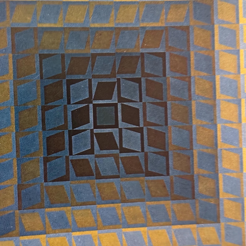 May include: Abstract geometric artwork featuring a repeating pattern of diamonds and squares. The design uses a palette of blue, brown, and gold, creating a visually dynamic and textured effect. The artwork has a retro, mid-century modern aesthetic.