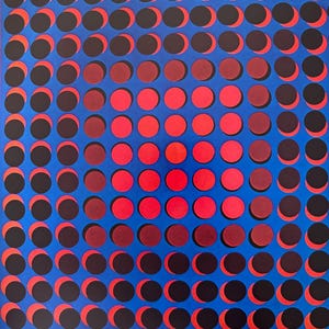 May include: Abstract art print with a grid of red and black circles on a bright blue background. The circles have a crescent shape, creating a visual illusion. The artwork is framed with a thin red border.