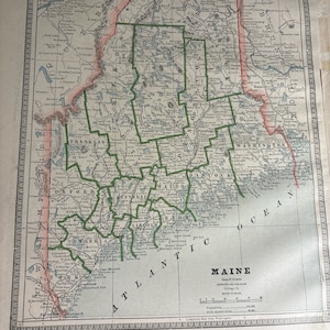 May include: A vintage map of Maine, USA, with county borders outlined in green and red. The map shows the state's coastline, rivers, lakes, and towns. The map is titled "Maine" and includes information about the state's population and area.