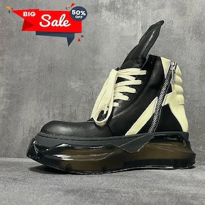 May include: Black and cream-colored high-top boot with a chunky, transparent sole. The boot features a side zipper, cream-colored laces, and a tall, folded-over tongue. The image also includes a red and white "Big Sale" banner with a "50% off" tag.