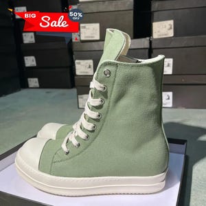 May include: High-top canvas sneakers in a light green hue with a white toe cap and sole. The sneakers feature white laces and eyelets. A red and white "BIG Sale" banner is visible in the top left corner.
