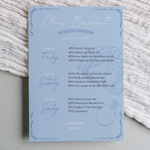 May include: A light blue card with a weekend itinerary for a bachelorette party. The card features a ring and a floral design. The itinerary includes activities for Friday, Saturday, and Sunday. June 6th, June 7th, June 8th, 2025.