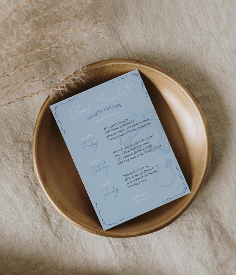 May include: A light blue card with a white outline and a floral design. The card lists a weekend itinerary for a bachelorette party with the days of the week, times, and activities. The text on the card reads "Olmaz's Bachelorette Weekend Itinerary".