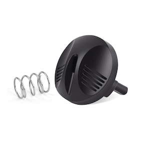 May include: A black bottle stopper with a spring. The stopper has a rounded top with a ridged design and a small stem. A silver-colored spring is next to the stopper.