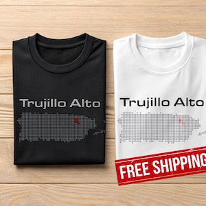 May include: Two t-shirts, one black and one white, with the text "Trujillo Alto" and a dotted outline of Puerto Rico. The black shirt has grey text and a red dot. The white shirt has black text and a red dot.