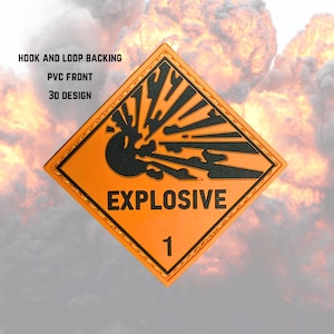 May include: An orange and black square patch with the word "EXPLOSIVE" and the number "1". The patch has a 3D design and features a hook and loop backing. The background shows an explosion.