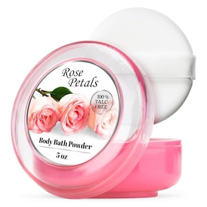 May include: A pink body bath powder container with a clear lid and a white powder puff. The label reads "Rose Petals" and "Body Bath Powder 5 oz." The label also states "100% TALC-FREE." The container features a floral design with pink roses.