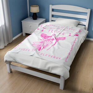 May include: White bedspread with a pink illustration of a woman with wings and the text "Goddess of Love Freyja Ruler of Folkvangr".