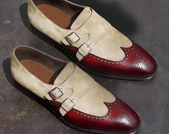 May include: Two-tone leather dress shoes with a burgundy and cream color scheme. The shoes have a wingtip design and double buckle closures.