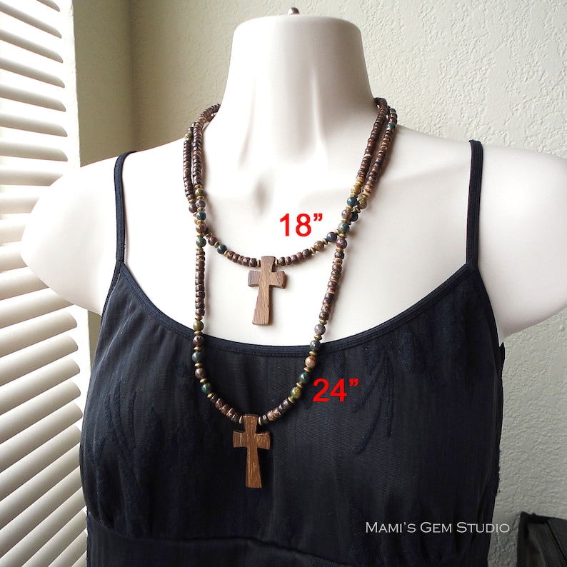 May include: Two wooden bead necklaces with cross pendants. The shorter necklace is 18 inches long and the longer necklace is 24 inches long.