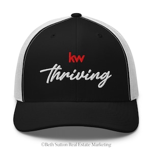 May include: Black and white trucker hat with a red "kw" logo and white cursive text that says "thriving".